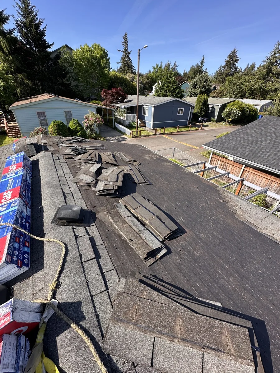 Tear-off of worn shingles during roof replacement, SE Foster Rd, Portland OR 97236