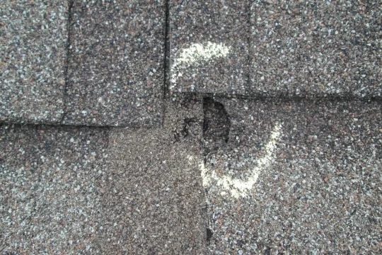 Storm-damaged shingle marked during inspection, Portland OR